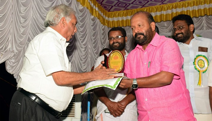 Pappy daniel receiving the special award from the Minister of Agriculature Mr. Sunilkumar